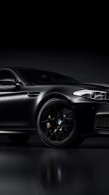 Sleek black sports sedan glowing gently in the dark studio.