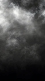 Dense grayscale cloud texture with diffuse light gradient.