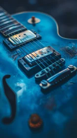 Close-up of blue electric guitar body and hardware.