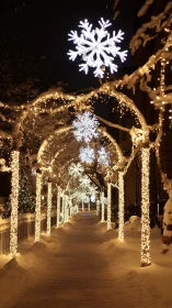 Snow-covered walkway under illuminated archway lights at night.