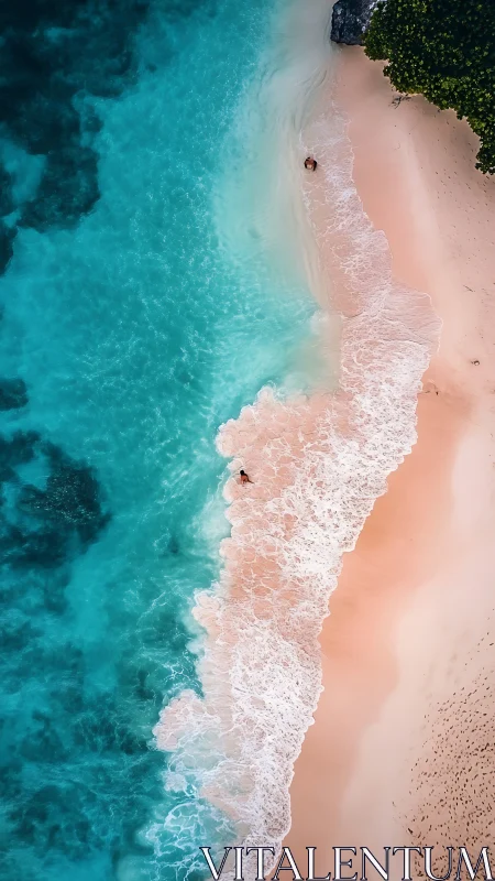 Aerial view of turquoise surf washing onto pastel sand shoreline