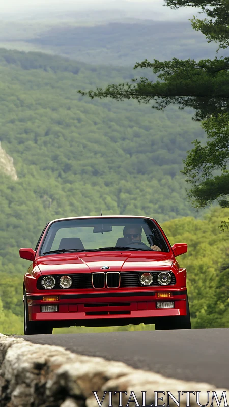 Classic red BMW cruising through peaceful mountain curves.