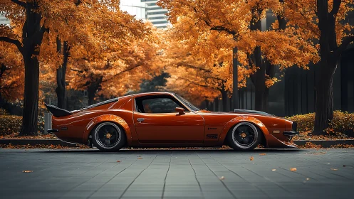Orange muscle car under autumn trees in city street.