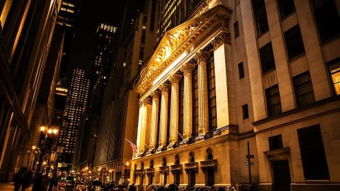 Illuminated neoclassical stock exchange facade at night.