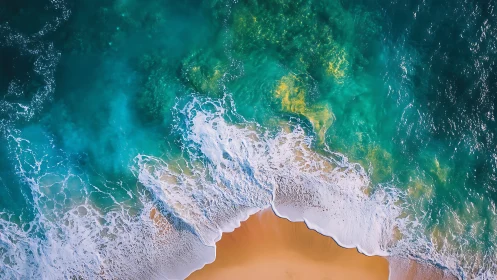 Tumbling turquoise waves sketch bright foam lace on sand