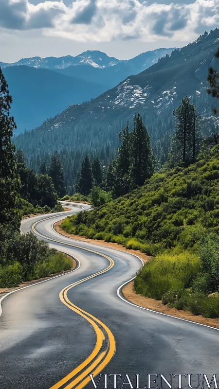 Ribboned mountain highway wriggles toward misty blue ranges