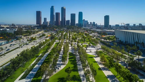 Urban park corridor runs toward dense downtown skyline