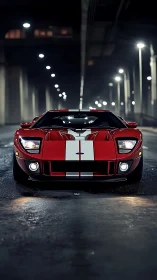 Low-angle frontal study of red GT sports car under tunnel lighting