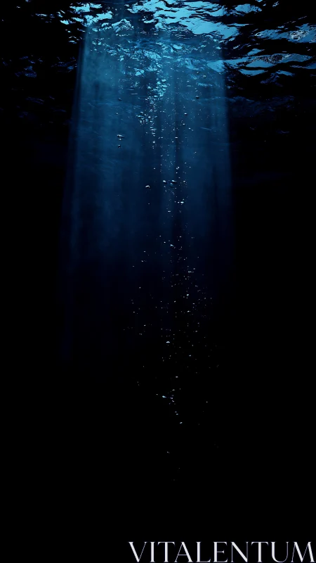 Vertical shaft of light and bubbles in dark underwater space.