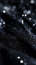 Dark macro surface with scattered white glitter bokeh.