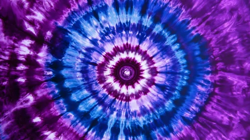 Spiraling tie-dye rings glow in vivid purple and blue waves