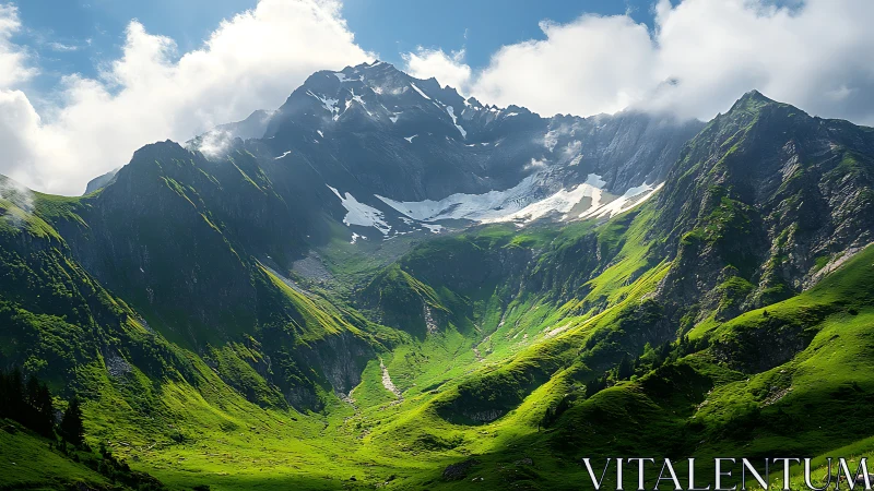 Mountain basin contains steep green slopes and residual snow