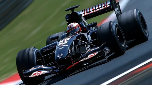 Black open-wheel race car moves along asphalt circuit