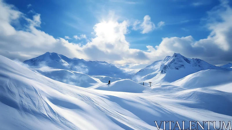 Snow-covered alpine valley with distant snowboarder under sun.