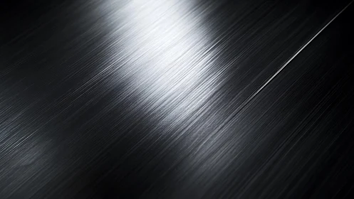 Close-up of Brushed Black Metal Surface with Light Reflection.