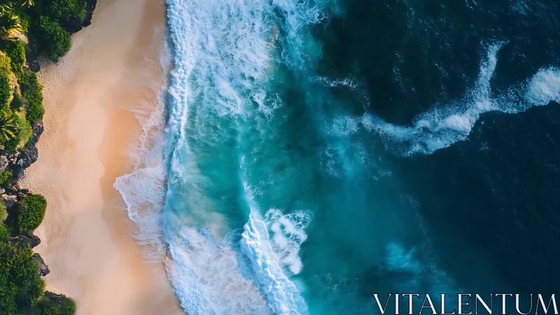 Tropical shoreline from above with crashing teal surf.