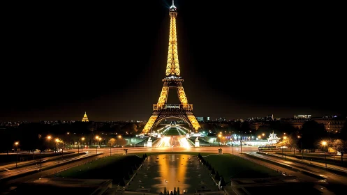 Eiffel Tower glows over Paris streets in deep nightscape.