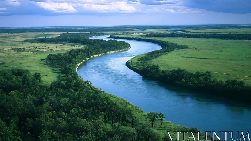 Meandering river cuts through verdant floodplain under stormfront