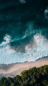 Shoreline symmetry from above, teal surf meets gold sand.