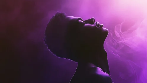 Profile of person in purple smoke and dramatic side light.