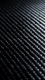 Carbon fiber weave macro with directional studio lighting.