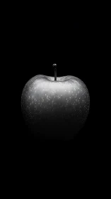 Monochrome apple isolated in dramatic black negative space.