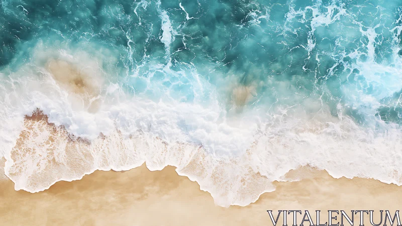 Overhead shoreline with foamy turquoise waves meeting sand.