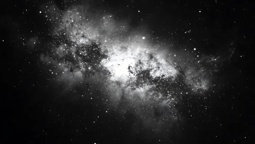 Starlit galaxy cloud drifts gently through a quiet black sky