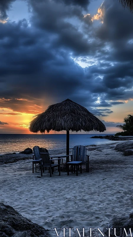 Dramatic sunset beach scene with palapa canopy and chairs