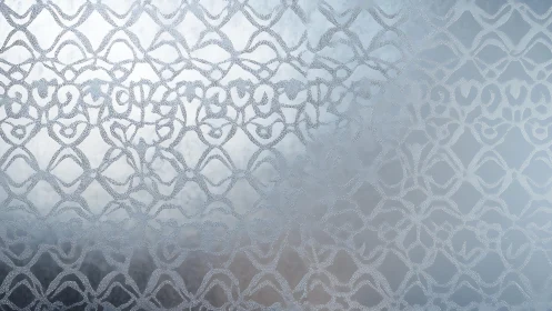 Frosted glass with intricate geometric pattern, soft blue tones.