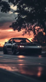Midnight black sports car glowing under a dreamy sunset sky.