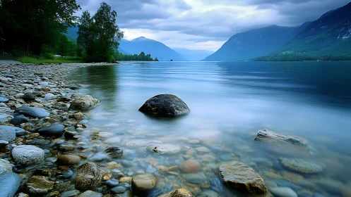 Long exposure alpine lake study with misted foreground stones