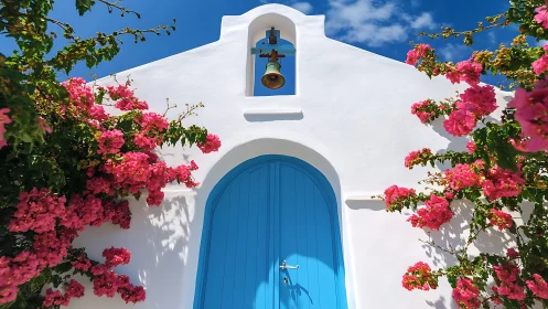 Bougainvillea crowns a blue chapel doorway under Cycladic skies