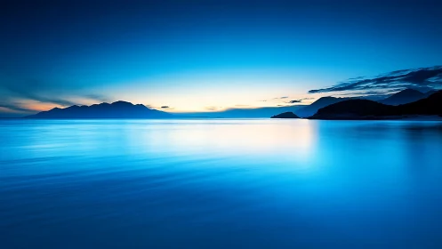 Blue coastal horizon captures tranquil predawn seascape