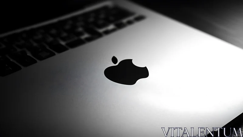 Oblique macro view isolates laptop logo with shallow depth of field