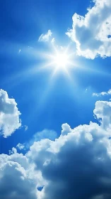 Radiant midday sunburst framed by towering cumulus clouds.