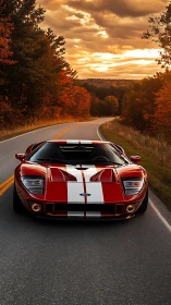 Low-angle frontal view of red sports car on winding rural asphalt