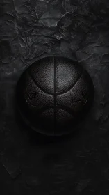 Monochrome basketball rests on textured dark surface