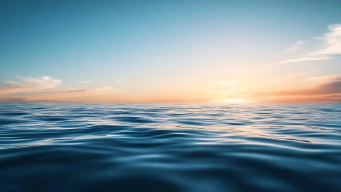 Calm ocean surface under soft sunrise sky horizon.