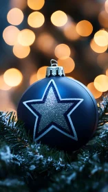 Blue star ornament with glitter detail and warm bokeh lights.