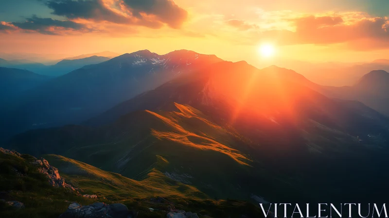 Mountain ridges under low sunset light over distant ranges.