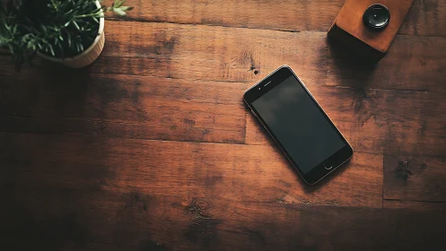 Smartphone on Wooden Desk with Accessories. Modern workspace setup.