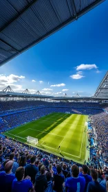 Wide-angle stadium crowd under dramatic cantilever roofline.