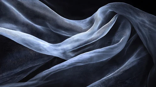 Billowing sheer fabric drifts softly across a dark backdrop