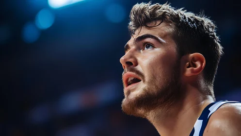 Focused basketball player in dramatic sidelight closeup portrait.