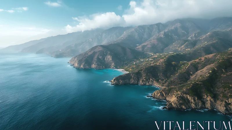Coastal mountain range with misty ridgelines and cyan wave refraction