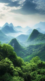 Mist veiled green mountains under soft morning sky.