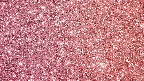 Pink glitter surface fills frame with dense reflective texture