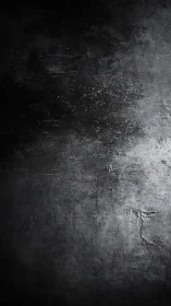 Dark concrete wall surface shows rough textured gradient lighting