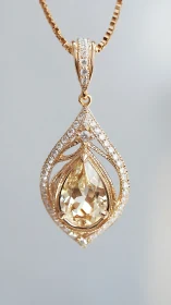Gold teardrop pendant with central gemstone and diamonds.